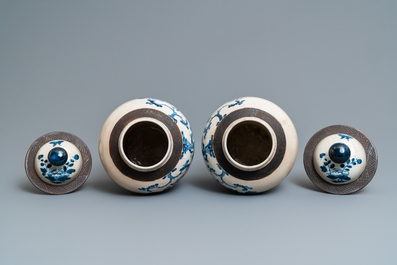 A pair of Chinese blue and white Nanking crackle-glazed vases and covers, 19th C.