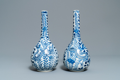 A pair of Chinese blue and white bottle vases with dragons, 19th C.