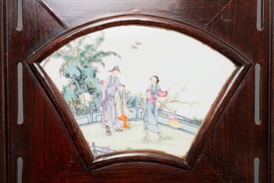 A Chinese wooden room divider with famille rose 'Romance of the Western Chamber' plaques, Republic