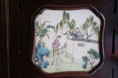 A Chinese wooden room divider with famille rose 'Romance of the Western Chamber' plaques, Republic