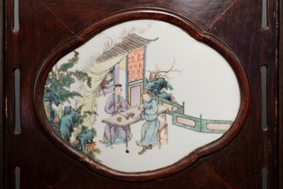 A Chinese wooden room divider with famille rose 'Romance of the Western Chamber' plaques, Republic