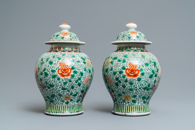 A pair of Chinese wucai 'Buddhist lion' vases and covers, 19/20th C.