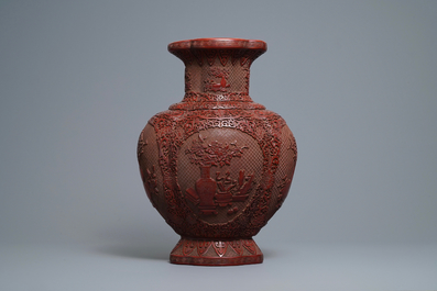 A Chinese carved cinnabar lacquer vase, Qianlong mark, 19/20th C.