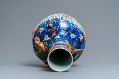 A large Chinese famille rose relief-decorated dragon and carps tianqiu ping vase, Kangxi mark, 19th C.