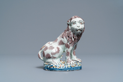 A polychrome Brussels or Lille faience model of a lion, late 18th C.