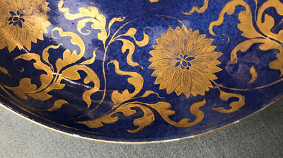 A Chinese powder blue and gilt dish with floral design, Kangxi