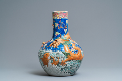 A large Chinese famille rose relief-decorated dragon and carps tianqiu ping vase, Kangxi mark, 19th C.
