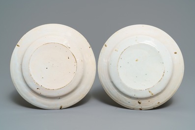 A pair of polychrome Brussels faience 'fish and cutlery' plates, 18th C.