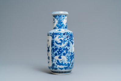 A Chinese blue and white rouleau vase with antiquities and floral designs, 19th C.