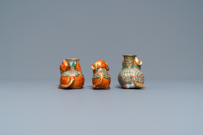 Three Chinese Canton famille rose models of dogs, two with candle holders, 19th C.