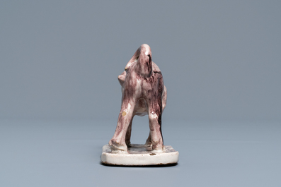 A manganese Lille faience model of a monkey, late 18th C.