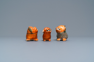 Three Chinese Canton famille rose models of dogs, two with candle holders, 19th C.
