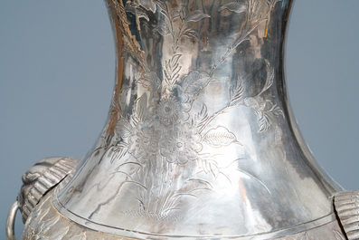 A pair of exceptional large Chinese relief-decorated silver vases, 19th C.