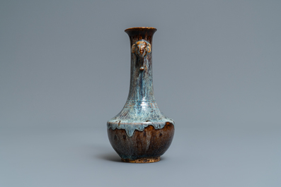 A Chinese flamb&eacute;-glazed vase with elephant head handles, 18/19th C.