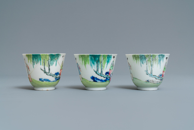 Three Chinese famille rose cups and saucers with figures in a garden, Yongzheng