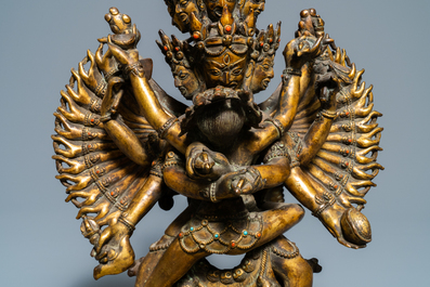 A large Sino-Tibetan coral-inlaid gilt bronze figure of Kapaladhara Hevajra, 18/19th C.