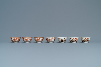 Fourteen Chinese iron-red and gilt cups and nine saucers, Kangxi/Qianlong