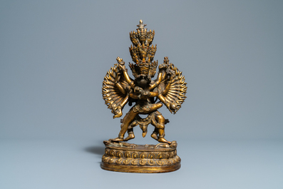 A large Sino-Tibetan coral-inlaid gilt bronze figure of Kapaladhara Hevajra, 18/19th C.