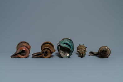 Fifteen islamic bronze and pottery oil lamps, 16th C. and later