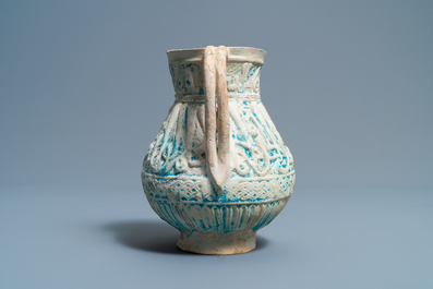 A Persian turquoise-glazed moulded calligraphic ewer, Kashan, 13/14th C.
