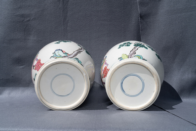 A pair of Chinese famille rose vases with figures in a garden, Yongzheng