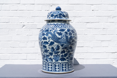 A pair of Chinese blue and white vases and covers with phoenixes, 19th C.