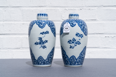 A pair of Chinese blue and white lidded jars with floral design, Kangxi