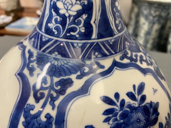 A Chinese blue and white bottle vase with floral design and antiquities, Kangxi