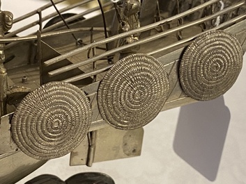 A large Chinese silver model of a junk on carved wooden stand, 19th C.