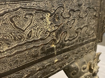 A large Chinese bronze censer and cover with animals near a hilly landscape, Ming