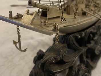 A large Chinese silver model of a junk on carved wooden stand, 19th C.