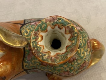 Three Chinese Canton famille rose models of dogs, two with candle holders, 19th C.