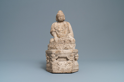 A Chinese carved stone group of Buddha on a throne, Wei or later