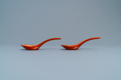 A pair of Chinese reverse-decorated iron red spoons, 19th C.