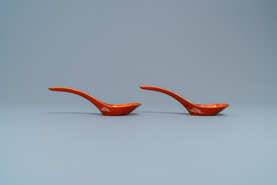 A pair of Chinese reverse-decorated iron red spoons, 19th C.