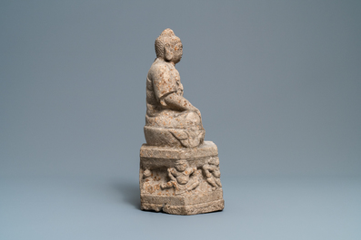 A Chinese carved stone group of Buddha on a throne, Wei or later