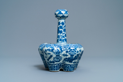 A Chinese blue and white tulip vase with antiquities, 19th C