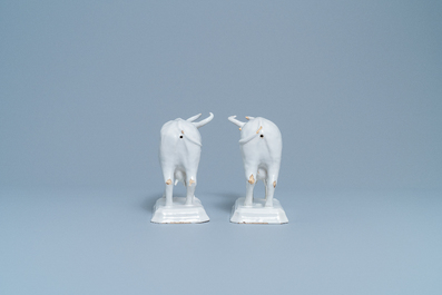 A pair of white Dutch Delftware cows on bases, 18th C.