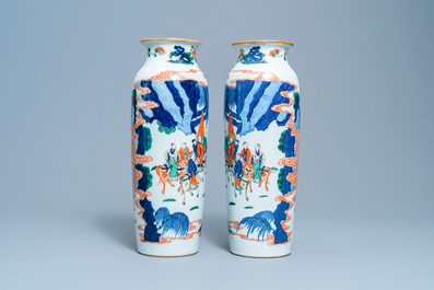 A pair of Chinese wucai rouleau vases with figures on horseback, 19th C.