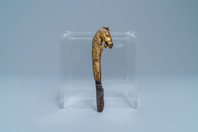 A Sino-Tibetan gilt bronze knife handle in the shape of a horse, Ming
