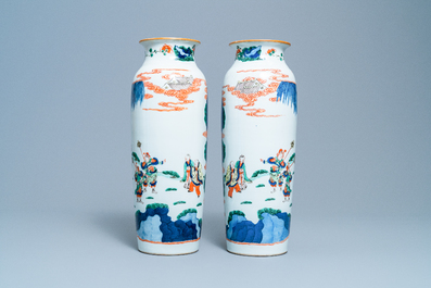 A pair of Chinese wucai rouleau vases with figures on horseback, 19th C.