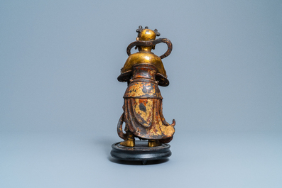A Chinese lacquered and gilt bronze figure of a servant, Ming