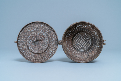 A reticulated polished steel bowl and cover with dragons, Tibet, 16/17th C.