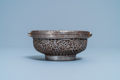 A reticulated polished steel bowl and cover with dragons, Tibet, 16/17th C.