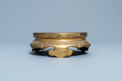 A Chinese gilt bronze stand, 19th C.