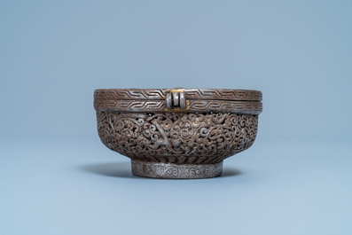 A reticulated polished steel bowl and cover with dragons, Tibet, 16/17th C.