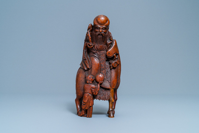 A Chinese carved bamboo group of Shou Lao on a deer, Ming