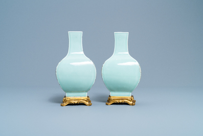 A pair of Chinese monochrome celadon vases with gilt bronze mounts, 18/19th C.