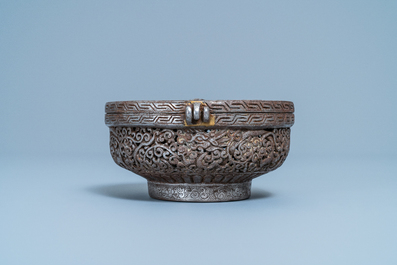 A reticulated polished steel bowl and cover with dragons, Tibet, 16/17th C.