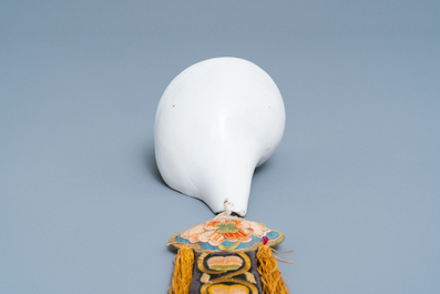 A TIbetan conch shell with embroidered silk ribbon, 19th C.